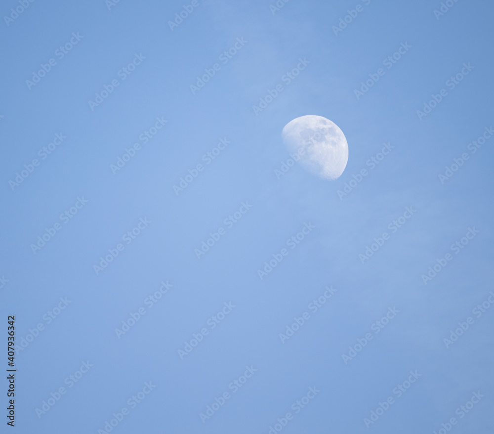 half moon in the sky at day time