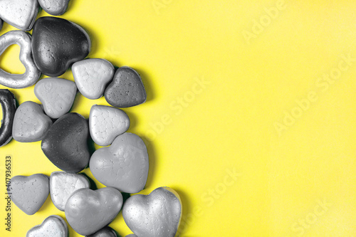 Gray hearts on a yellow background  trending colors of 2021. Copy space  modern Valentine s Day concept.