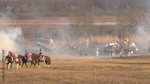 Reconstruction of the battle of 1812, the Russian army attacks the French near the Berezina River, soldiers fire cannons and rifles, cavalry gallops, general plan; Belarus, 3. photo