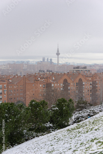 Vertical shot of the buildings of Madrid from Vallecas, Spain on a snowy cloudy day photo