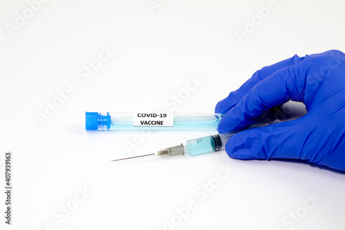 Medical professional holding a syringe with covid-19 virus vaccine