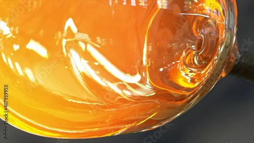 Glass handmade production, golden ball of hot glass.