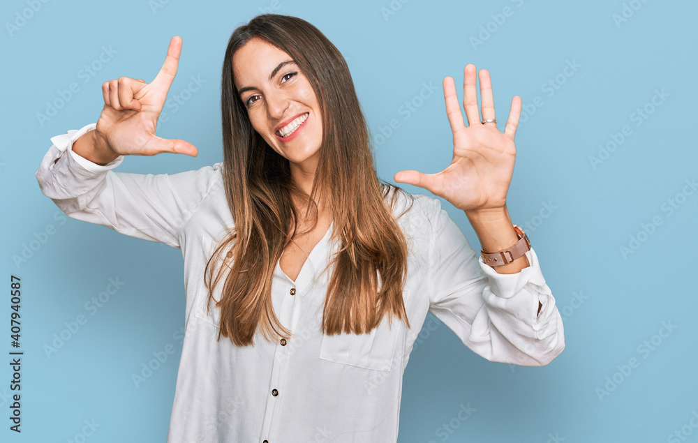 Young beautiful woman wearing casual clothes showing and pointing up with fingers number seven while smiling confident and happy. Young beautiful woman wearing casual clothes showing and pointing up with fingers number seven while smiling confident and happy.