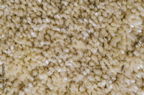 Beige frieze material for carpeting close-up