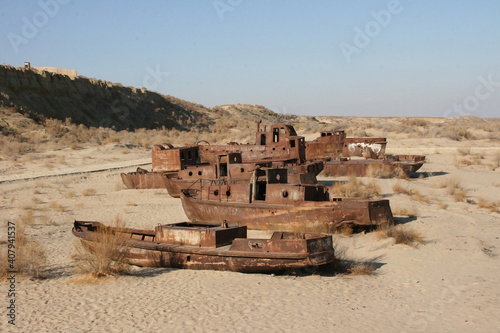 Moynaq (Mo‘ynoq or Muynak), Uzbekistan - Desember 06 2019:  an abandoned rusty ship in the Aral sea. Ecological disaster. Dry bottom of the Aral Sea. World famous as the largest man made disaster. 