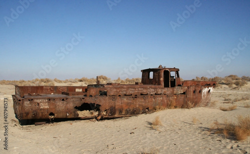 Moynaq (Mo‘ynoq or Muynak), Uzbekistan - Desember 06 2019: an abandoned rusty ship in the Aral sea. Ecological disaster. Dry bottom of the Aral Sea. World famous as the largest man made disaster. 