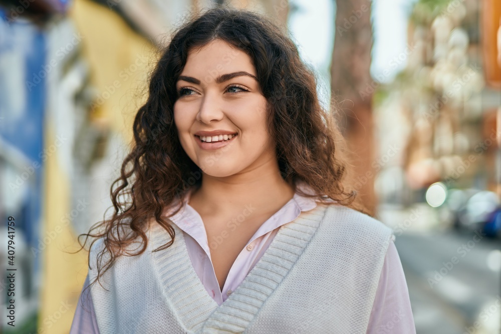 Young hispanic woman smiling happy standing at the city.