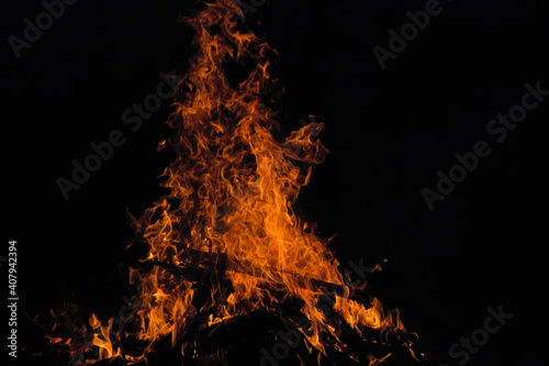 Large red bonfire in the dark. Fire twigs at night.