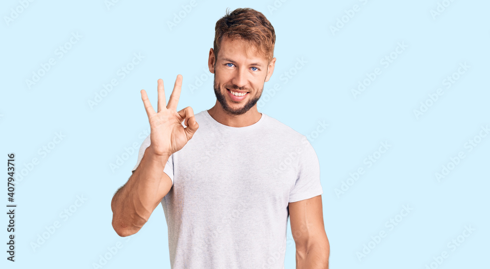 Young caucasian man wearing casual white tshirt showing and pointing up with fingers number three while smiling confident and happy. Young caucasian man wearing casual white tshirt showing and pointing up with fingers number three while smiling confident and happy.