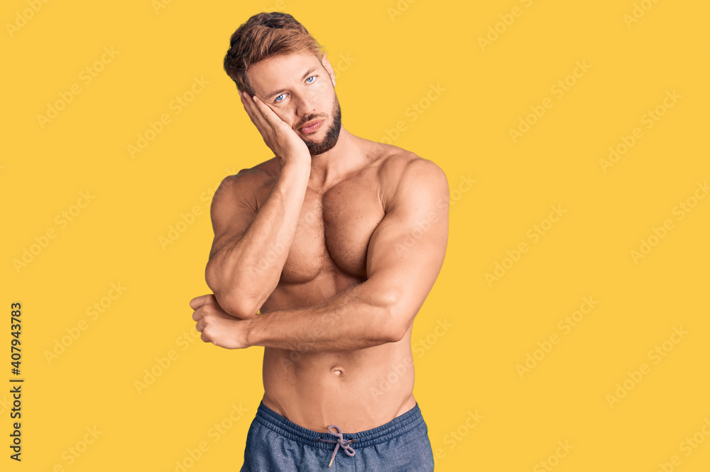 Fototapeta premium Young caucasian man standing shirtless thinking looking tired and bored with depression problems with crossed arms.