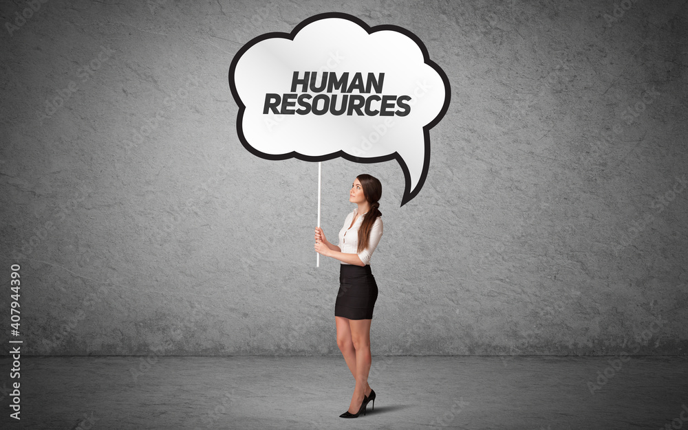 Young business person in casual holding road sign with HUMAN RESOURCES inscription, new business idea concept Young business person in casual holding road sign with HUMAN RESOURCES inscription, new business idea concept