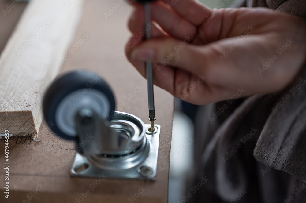 female hands placing the wheel bolts female hands placing the wheel bolts