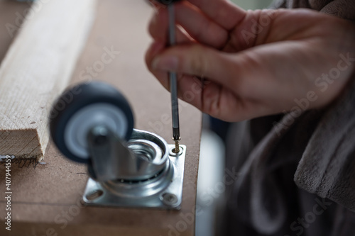 female hands placing the wheel bolts