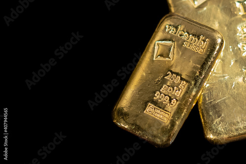 Valcambi Suisse gold bullion bar on black background. Large cast investment gold ingot. Swiss gold. Business and finance.