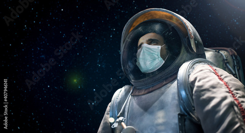 Fototapeta Naklejka Na Ścianę i Meble -  Astronaut looking at the infinite space while wearing a mask, covid coronavirus funny concept
