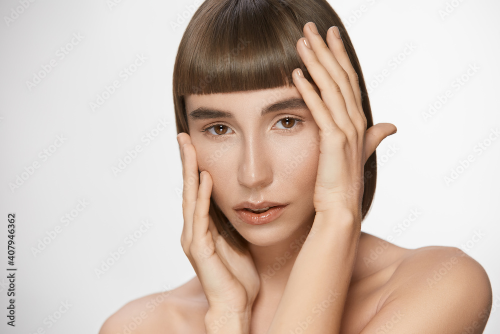 glamourous woman with perfect skin touching her face with arms glamourous woman with perfect skin touching her face with arms