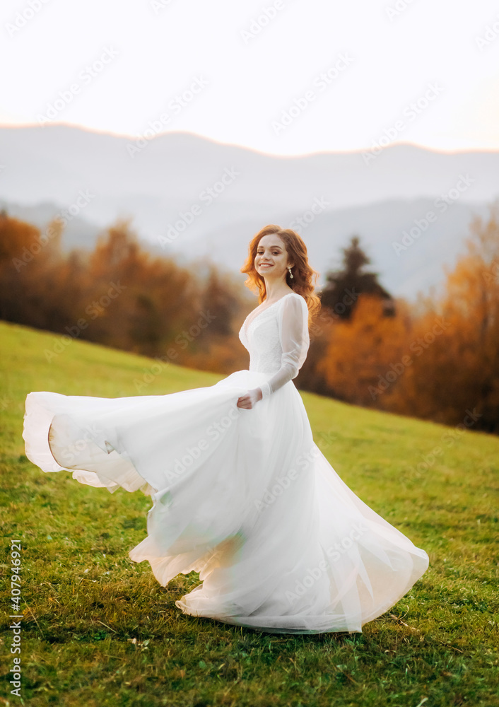 Young bride in wedding dress runing at sunset in the mountains Young bride in wedding dress runing at sunset in the mountains