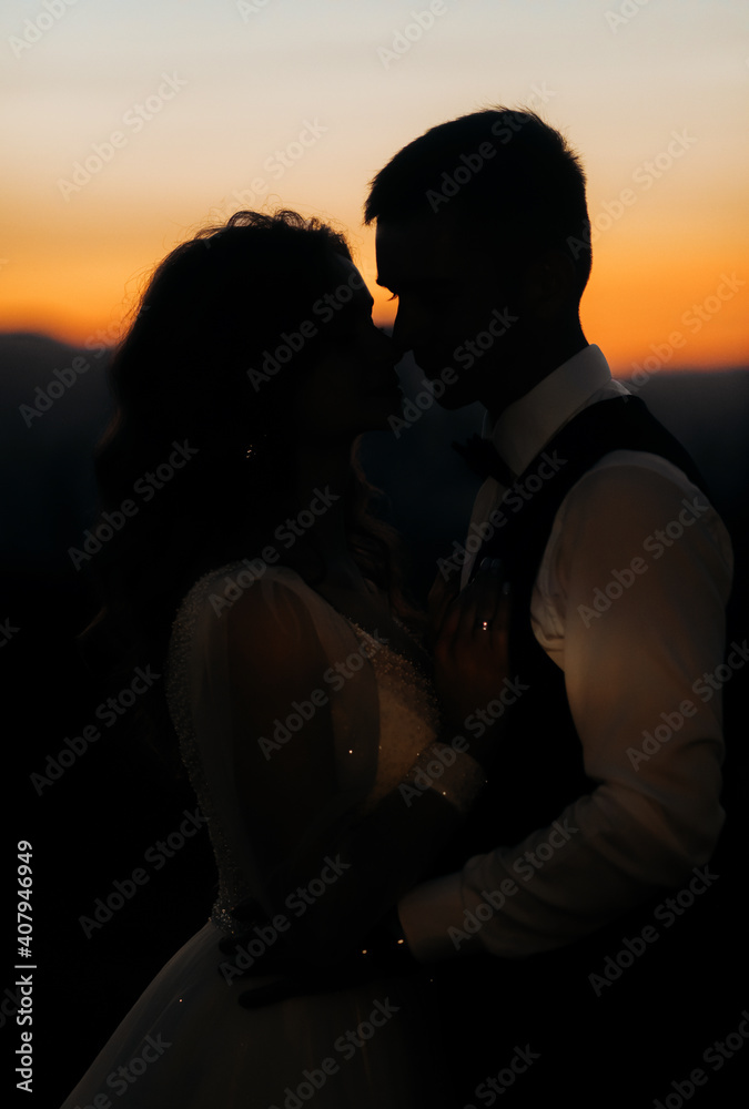 Romantic couple on the background of evening mountains