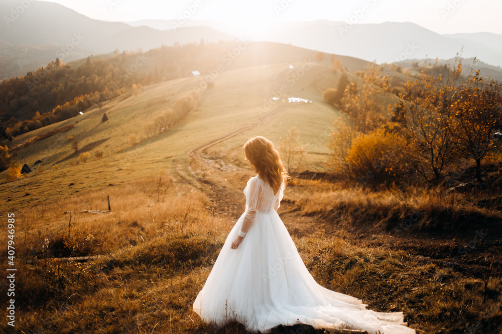 Pretty bride walking on a mountain meadow Pretty bride walking on a mountain meadow