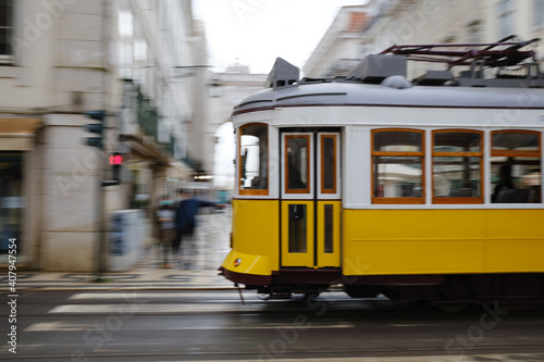 The typical yellow tram through the streets of Lisbon, Portugal