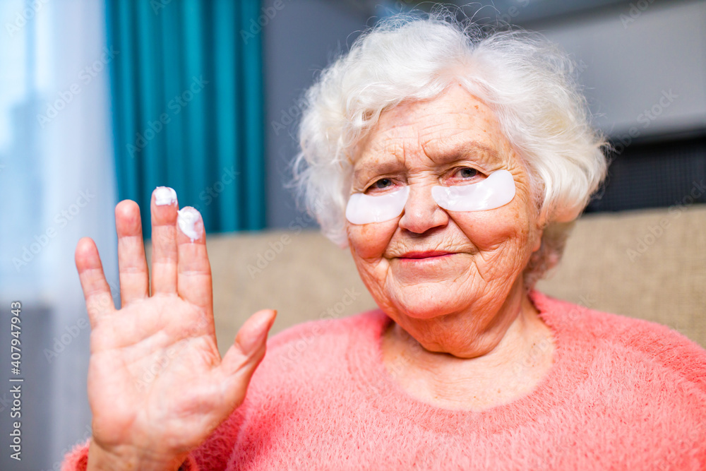 portrait of smiling senior woman with hydrogel under-eye patches portrait of smiling senior woman with hydrogel under-eye patches