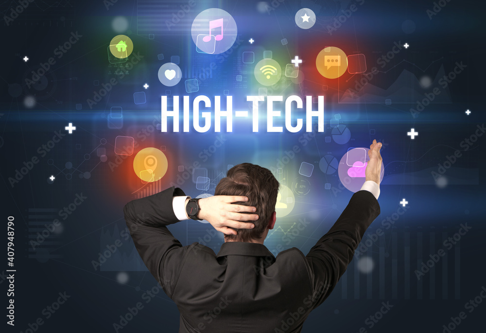 Rear view of a businessman with HIGH-TECH inscription, modern technology concept Rear view of a businessman with HIGH-TECH inscription, modern technology concept