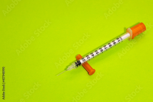 Insulin syringe for diabetes isolated on green background. Close-up empty syringe isolated. Plastic insulin syringe. Injection medicine. Medical equipment.