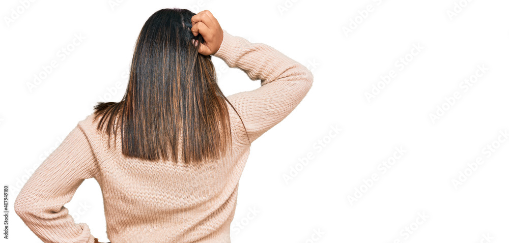 Young latin girl wearing wool winter sweater backwards thinking about doubt with hand on head Young latin girl wearing wool winter sweater backwards thinking about doubt with hand on head
