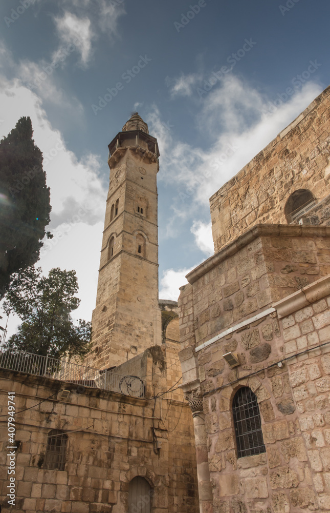 Part facade of the Church of the Holy Sepulchre  and minaret of the mosque of Omar in Jerusalem