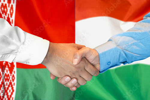 Business handshake on the background of two flags. Men handshake on the background of the Belarus and Hungary flag. Support concept
