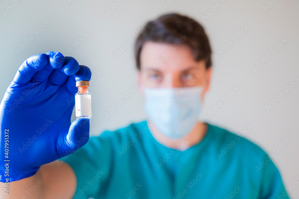male doctor with covid vaccine in hand. Vaccination and immunization male doctor with covid vaccine in hand. Vaccination and immunization