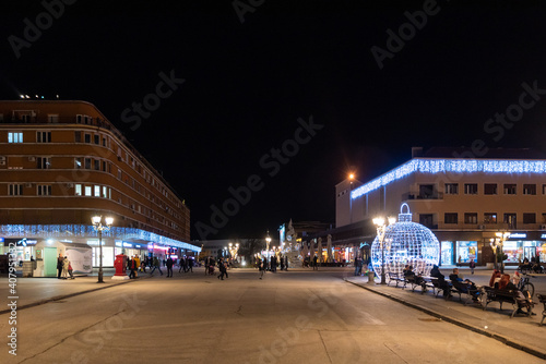 Night images of city center of Novi Sad with building architecture and night life with people selective focus with film grain. © Srdjan