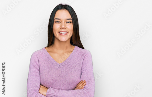 Young hispanic girl wearing casual clothes happy face smiling with crossed arms looking at the camera. positive person. © Krakenimages.com
