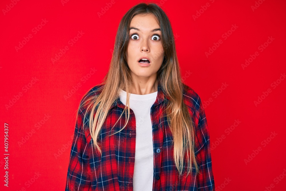 Beautiful caucasian woman wearing casual clothes scared and amazed with open mouth for surprise, disbelief face Beautiful caucasian woman wearing casual clothes scared and amazed with open mouth for surprise, disbelief face