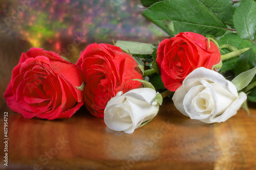 Beautiful bouqet of roses on red wood table  summer flowers fragrant 