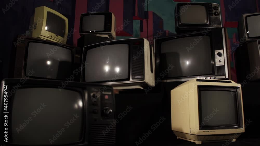 Pile of Retro TVs and One Old Vintage Television turning on Green Screen. Dolly Shot. 4K Resolution.