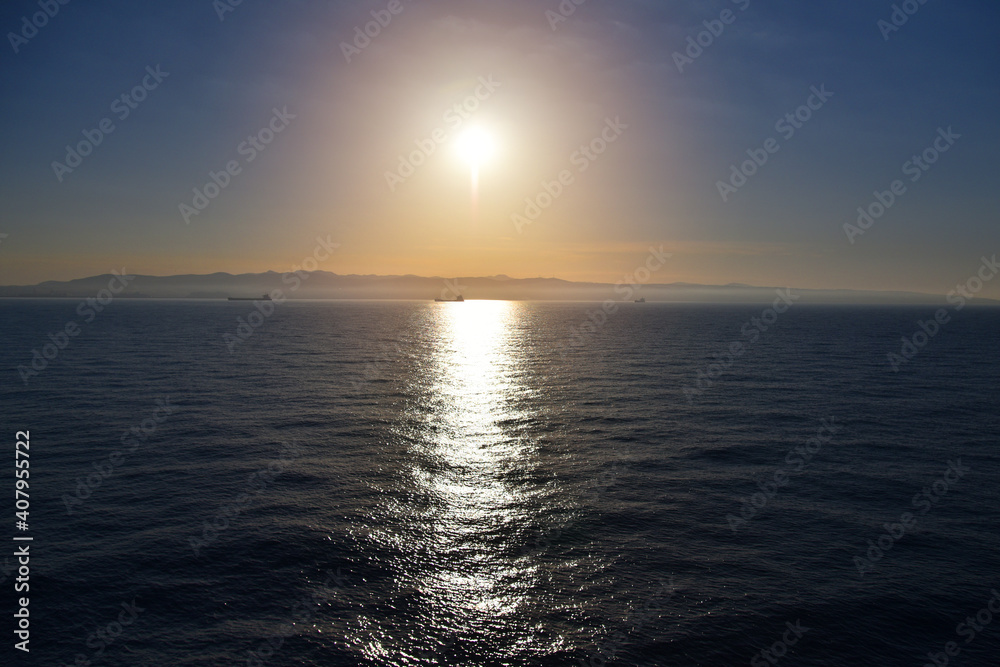 Fototapeta premium Summer cruise vacation concept. Panoramic view of the sea with a beautiful sunset just above the horizont.