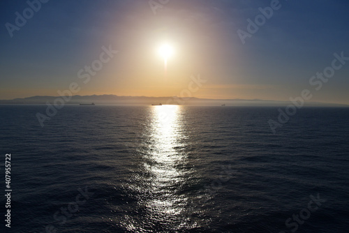 Summer cruise vacation concept. Panoramic view of the sea with a beautiful sunset just above the horizont.