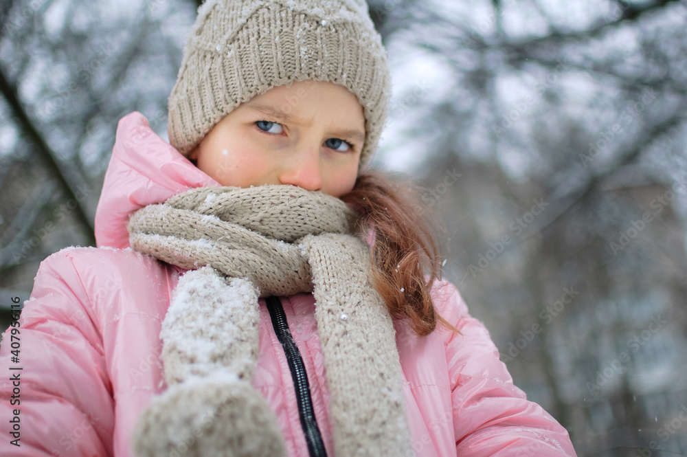 Little upset girl is wearing pink clothes in the park and crying. Unhappy kid got frozen spending time outdoors during cold winter Little upset girl is wearing pink clothes in the park and crying. Unhappy kid got frozen spending time outdoors during cold winter