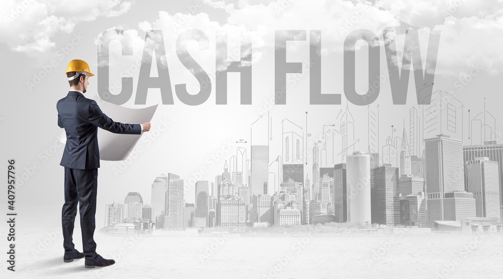 Young businessman with hard hat and CASH FLOW inscription, new business opportunity concept Young businessman with hard hat and CASH FLOW inscription, new business opportunity concept
