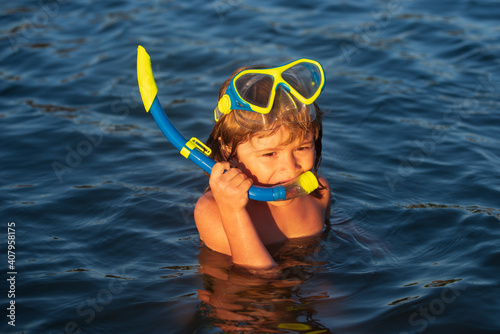 Little boy swimming and snorkeling in tropical ocean or sea.