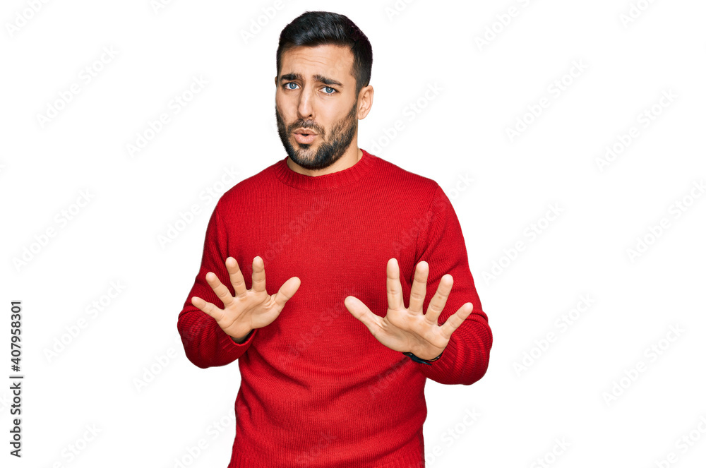 Young hispanic man wearing casual clothes moving away hands palms showing refusal and denial with afraid and disgusting expression. stop and forbidden. Young hispanic man wearing casual clothes moving away hands palms showing refusal and denial with afraid and disgusting expression. stop and forbidden.