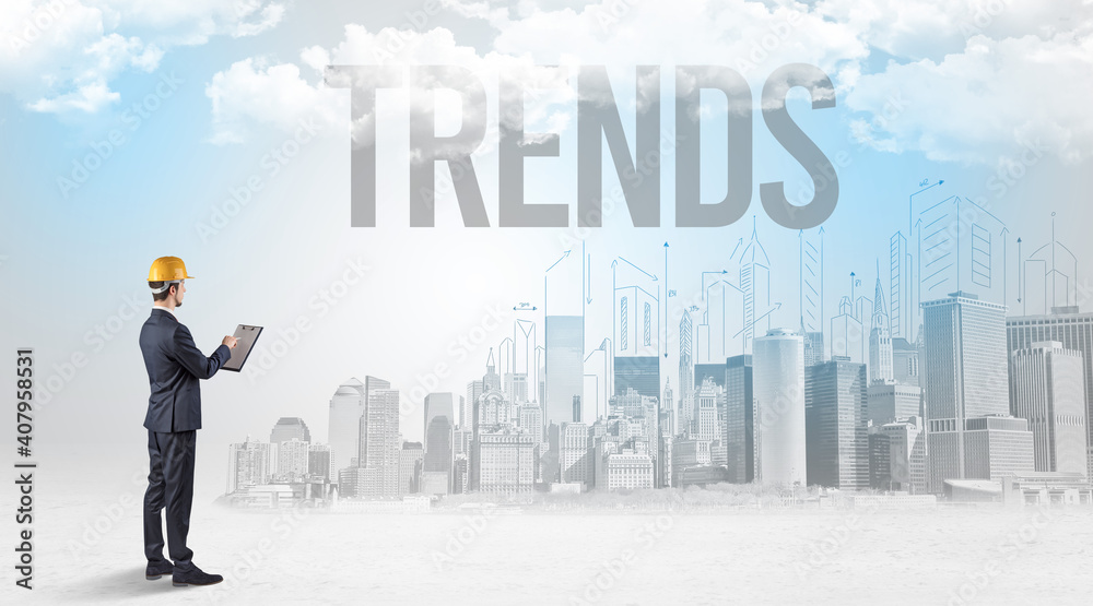 Young businessman with hard hat and TRENDS inscription, new business opportunity concept Young businessman with hard hat and TRENDS inscription, new business opportunity concept
