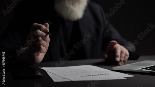 Thoughtful oligarch hesitating to sign contract, holding pen, business agreement photo