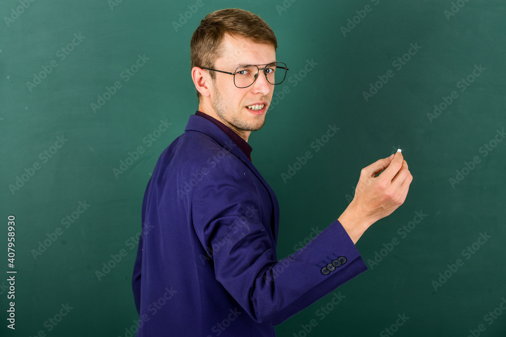 university teacher write on blackboard. student study in college. modern education concept. young but skilled businessman. typical office worker. man wear glasses and jacket. back to school university teacher write on blackboard. student study in college. modern education concept. young but skilled businessman. typical office worker. man wear glasses and jacket. back to school