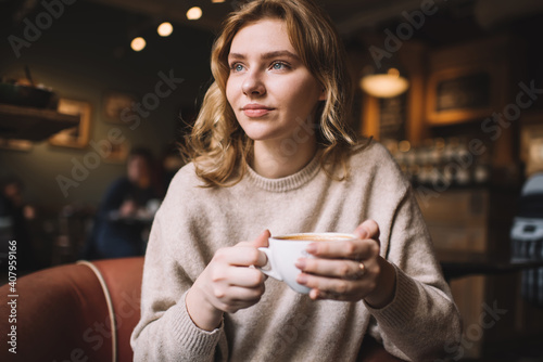 Pensive woman with cup of coffee