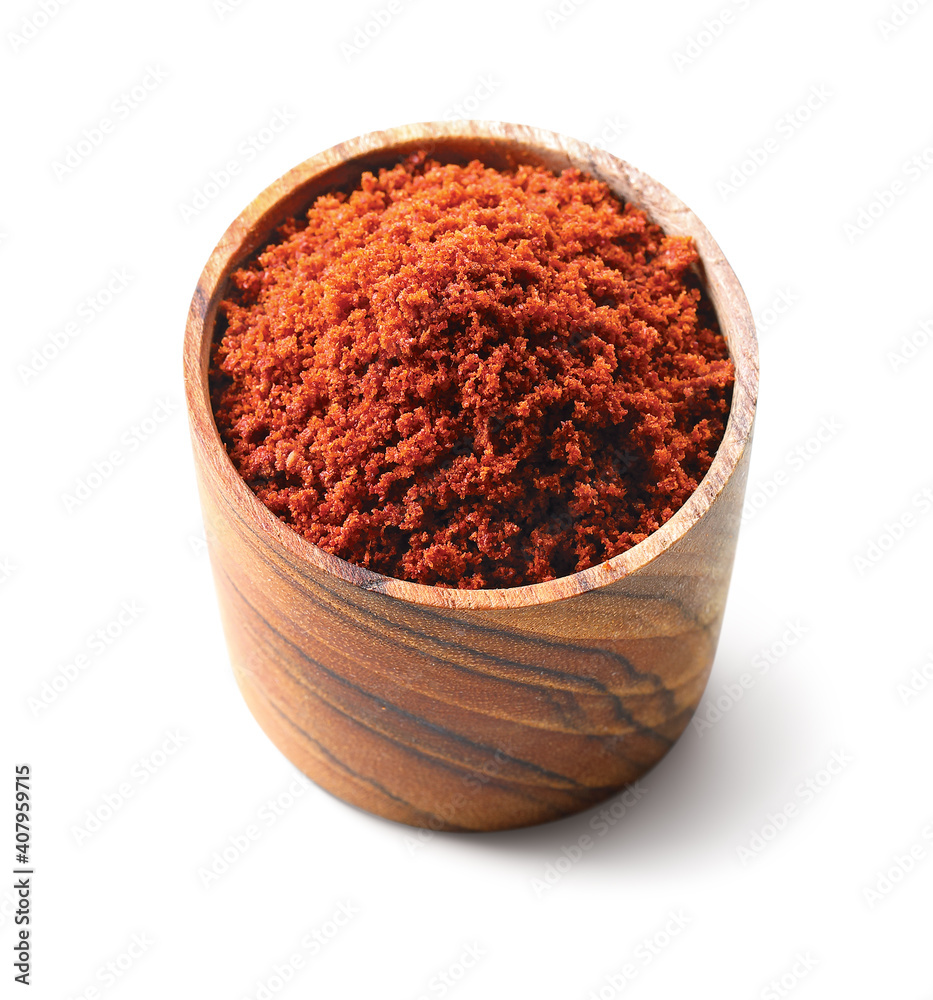 Red spicy chili powder in a wooden dish bowl isolated on white background Red spicy chili powder in a wooden dish bowl isolated on white background