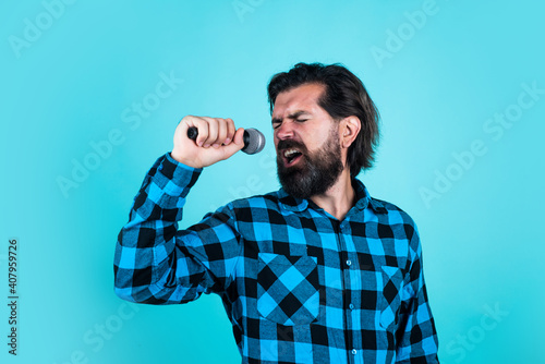 emotional bearded man singing a song in microphone at karaoke, music