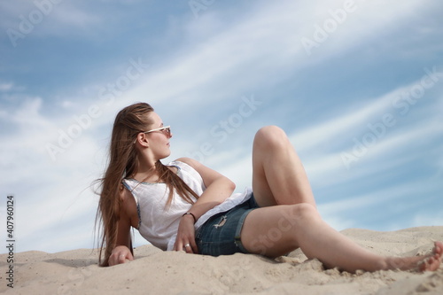 girl on the beach against the blue sky