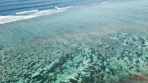 Lombok, Indonesia, south Gili islands. Aerial drone view from Gili Asahan island. A strip of sand on the beach and blue sea with corals photo